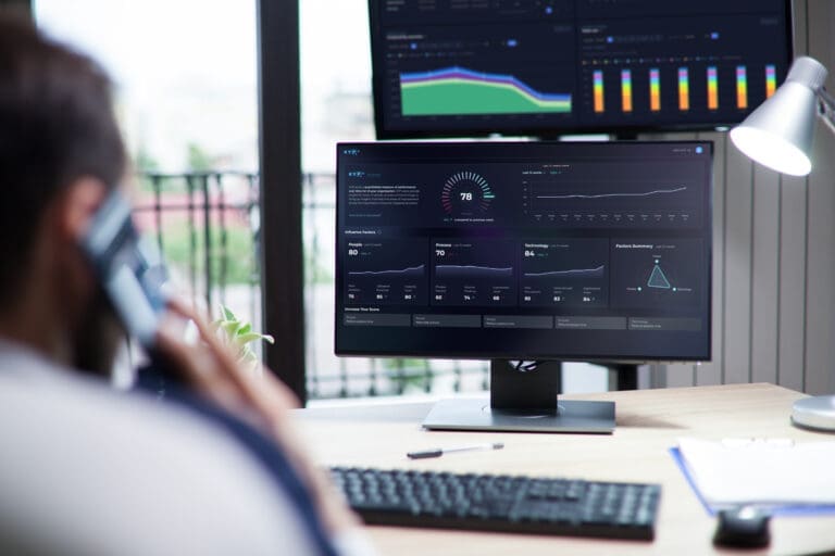 Data analyst examines KPI metrics on performance dashboard using KYP.ai platform, featuring colorful charts for process optimization